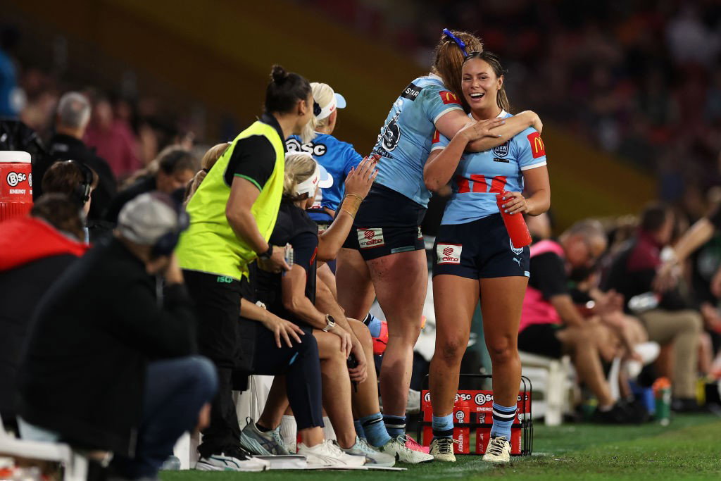 Taliah Fuimaono is hugged on the sidelines for NSW Sky Blues during Women's State of Origin.