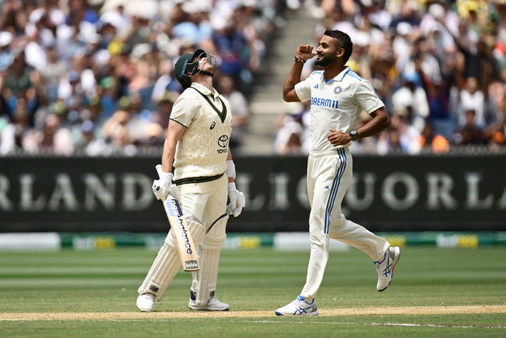 Steve Smith throws his head back as Akash Deep celebrates his wicket.