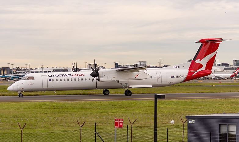 A small QantasLink plane at an airport.
