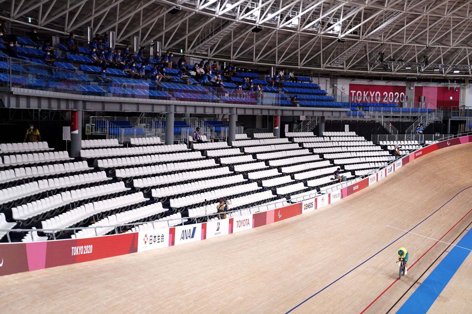 Australia's Emily Petricola rides to victory in the women's C4 3000m individual pursuit in Tokyo, amid empty stands.