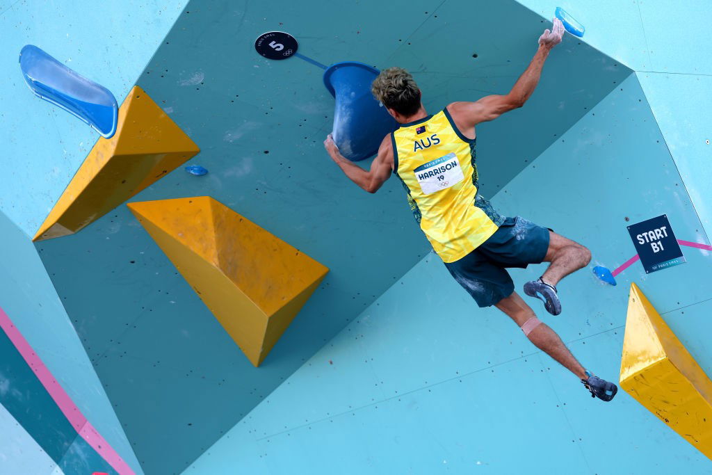 Campbell Harrison tries a move on a boulder problem at the Paris Olympics.
