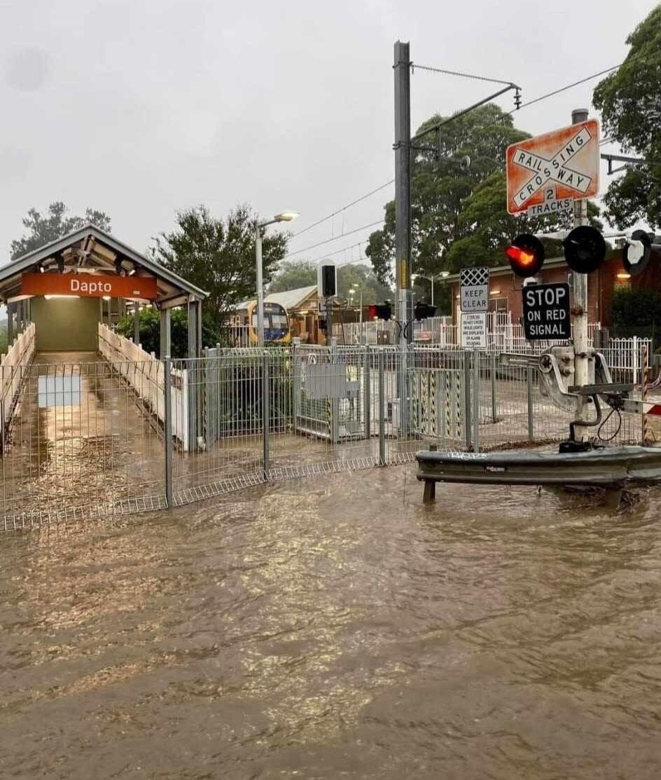 Flooding with a dapto train station sign visible