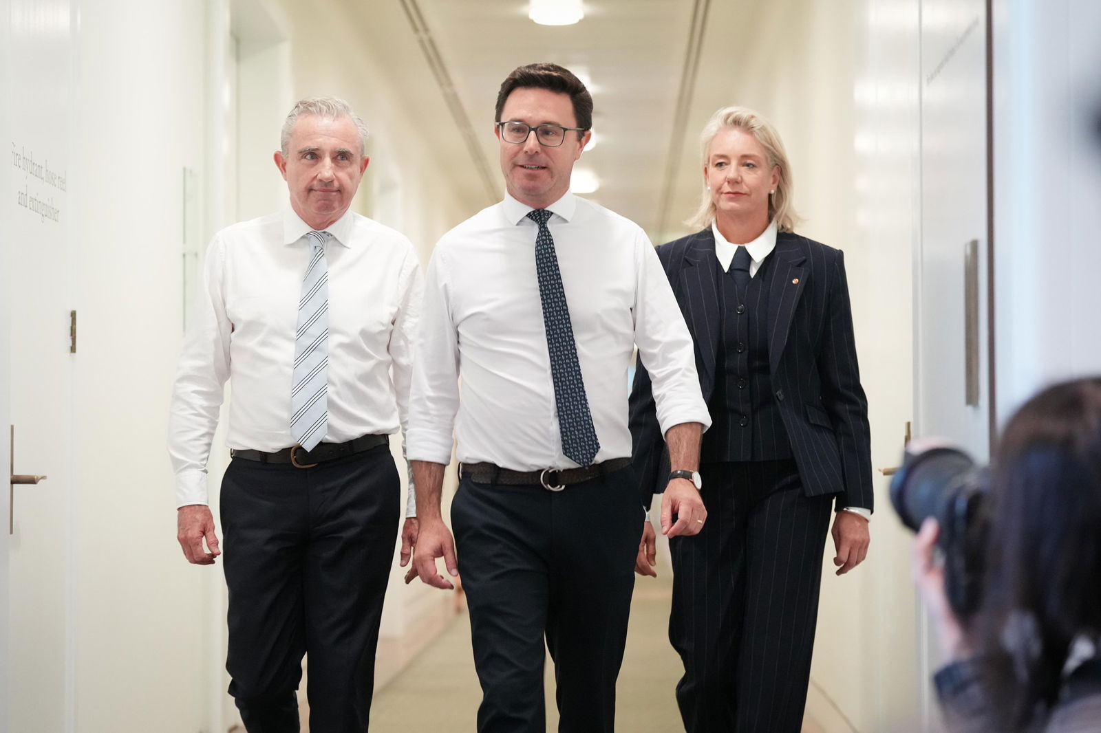 david littleproud, bridget mckenzie and kevin hogan walk alongside each other