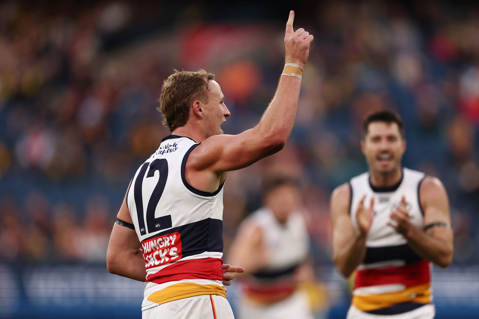 Jordan Dawson celebrates a Crows' AFL goal.