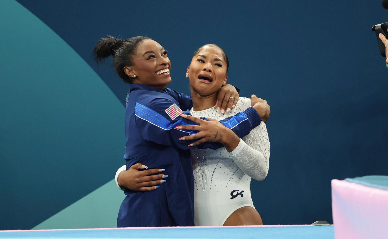 Simone Biles hugs US gymnastics teammate Jordan Chiles at the Paris Olympics.