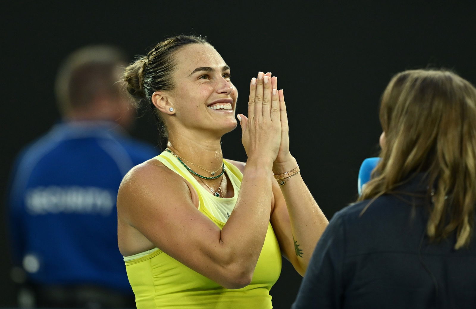 Aryna Sabalenka puts her hands together in a praying motion.