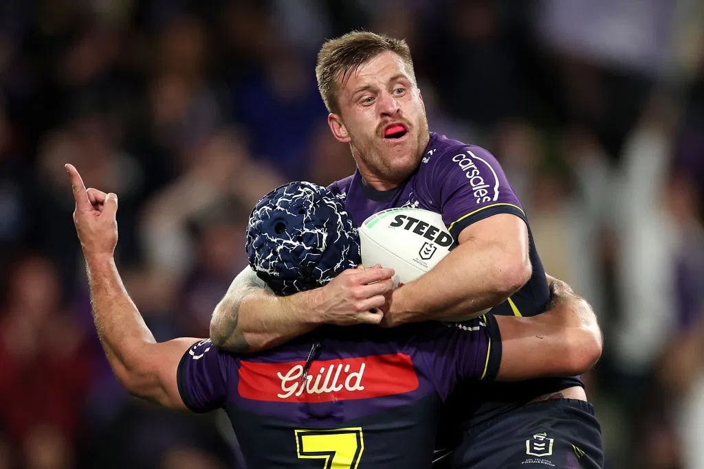 Cameron Munster jumps on Melbourne Storm teammate Jahrome Hughes after scoring a try in the NRL finals.