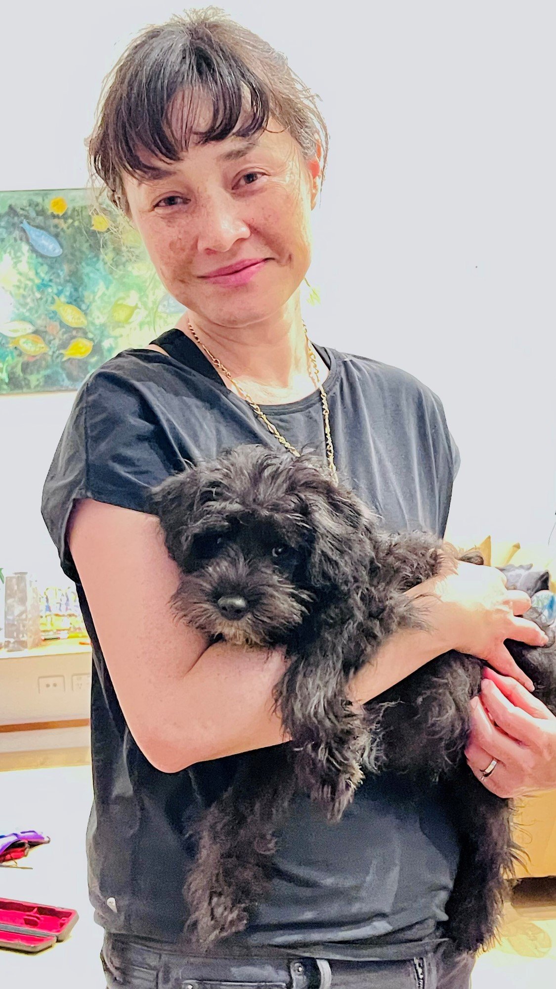 A woman holding her dog.