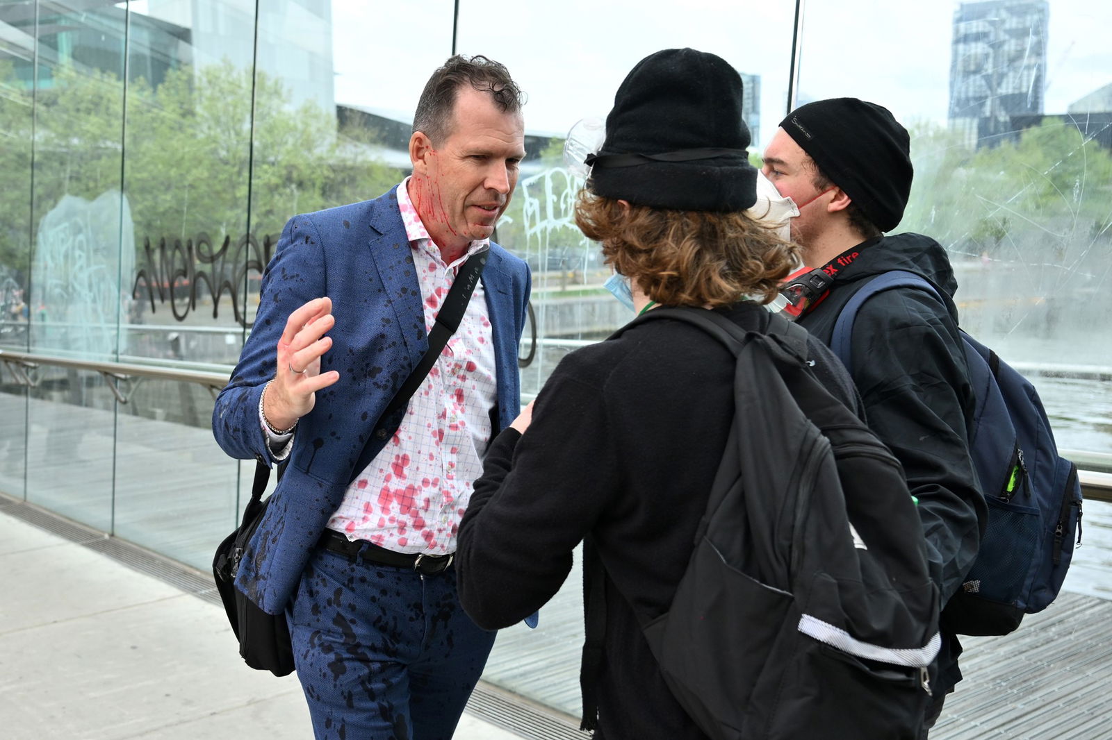 Protesters surrounding a man