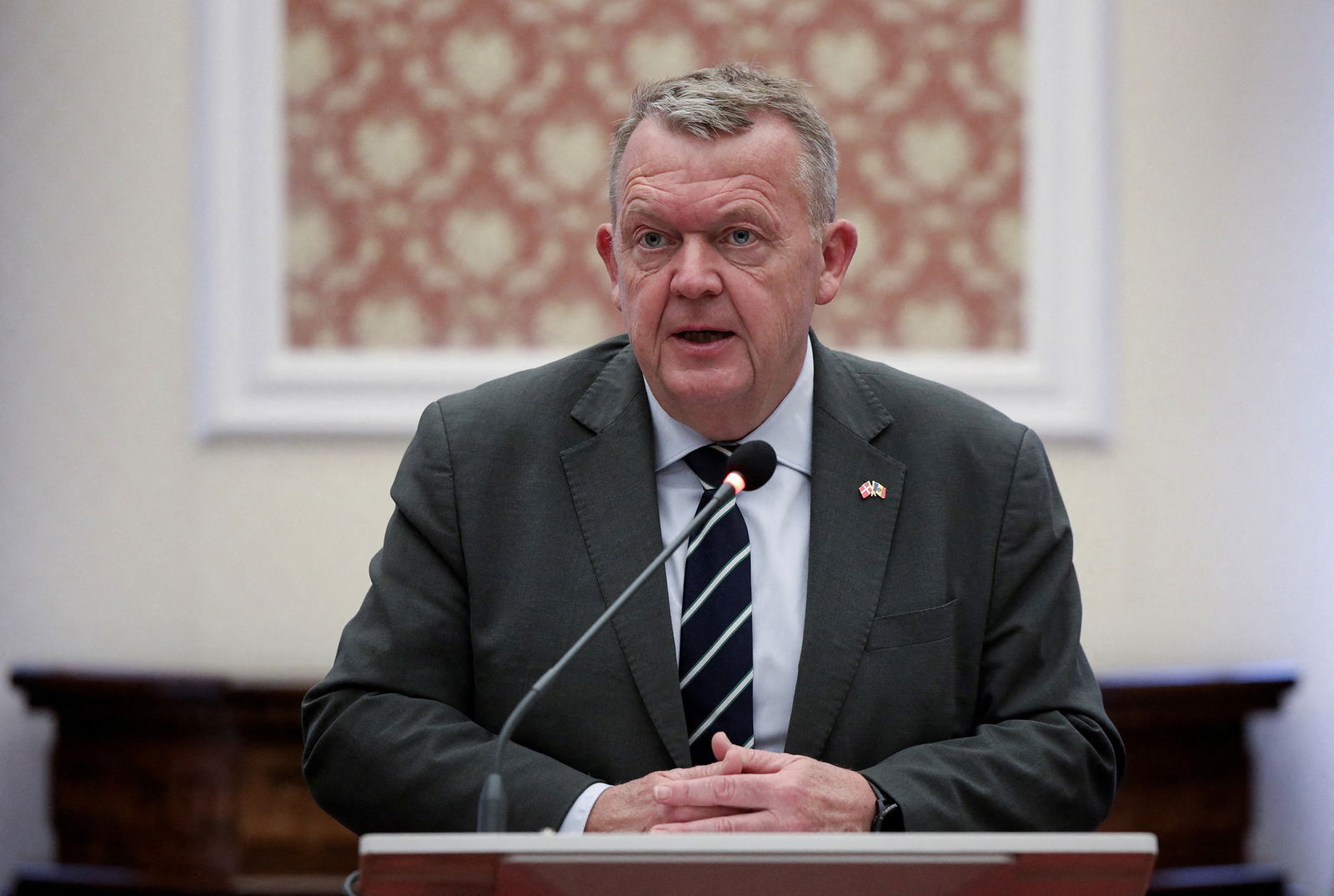 Lars Lokke Rasmussen sitting at a microphone. 