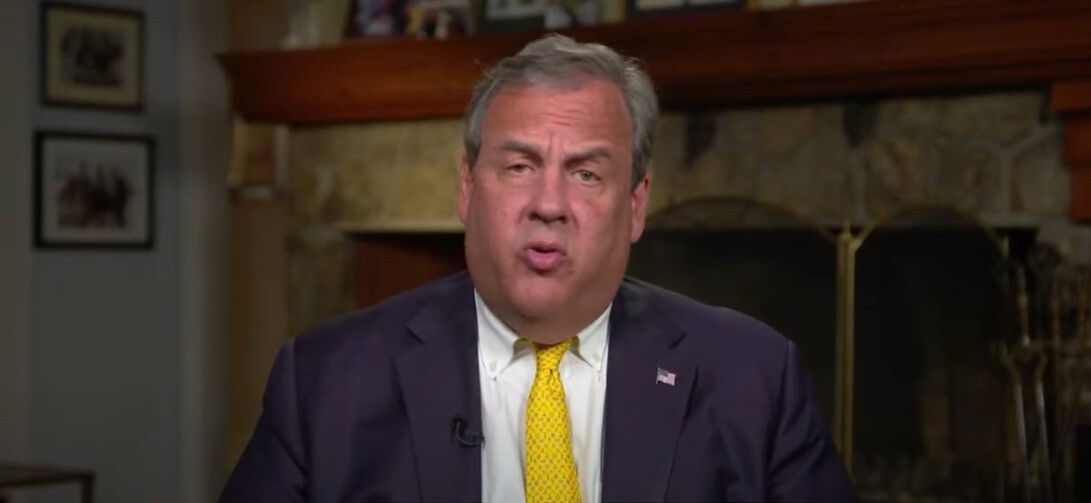 An older middle-aged man in a yellow tie.