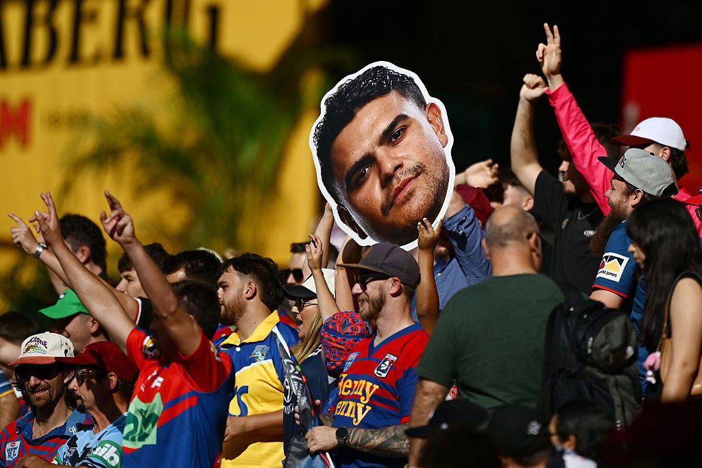 NRL fans holding up a photo of Latrell Mitchell's head.