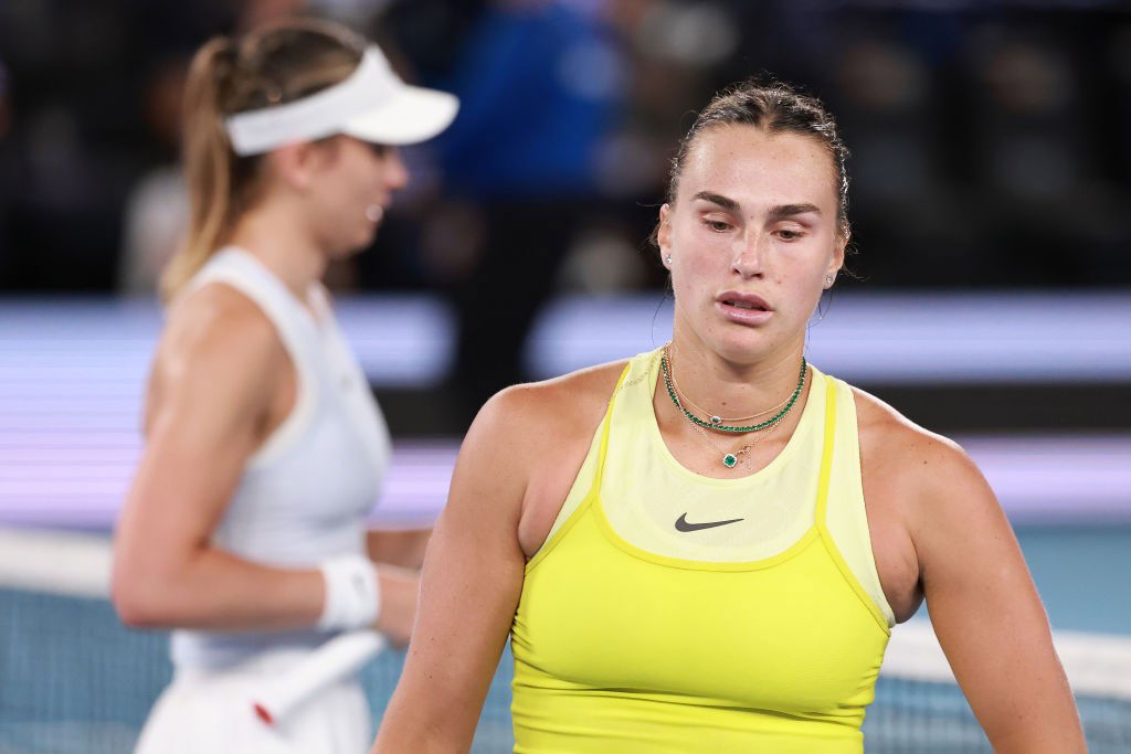 Aryna Sabalenka and Paula Badosa walk past each other during the Australian Open semifinal.