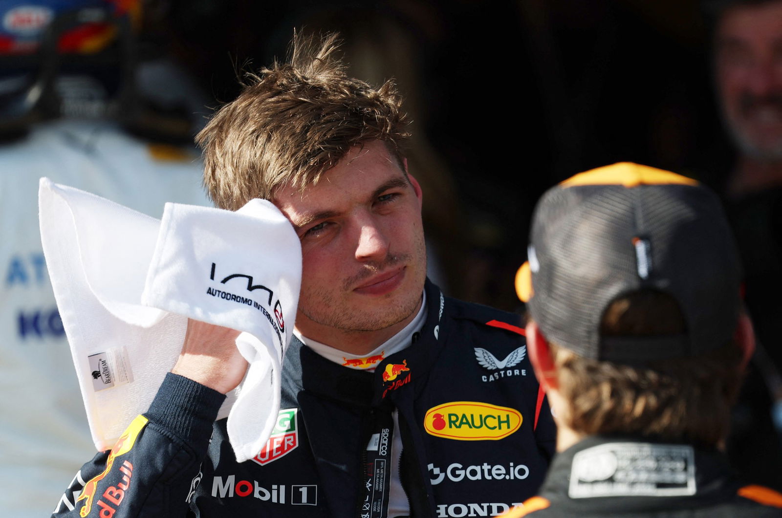 Max Verstappen wiping his face with a towel