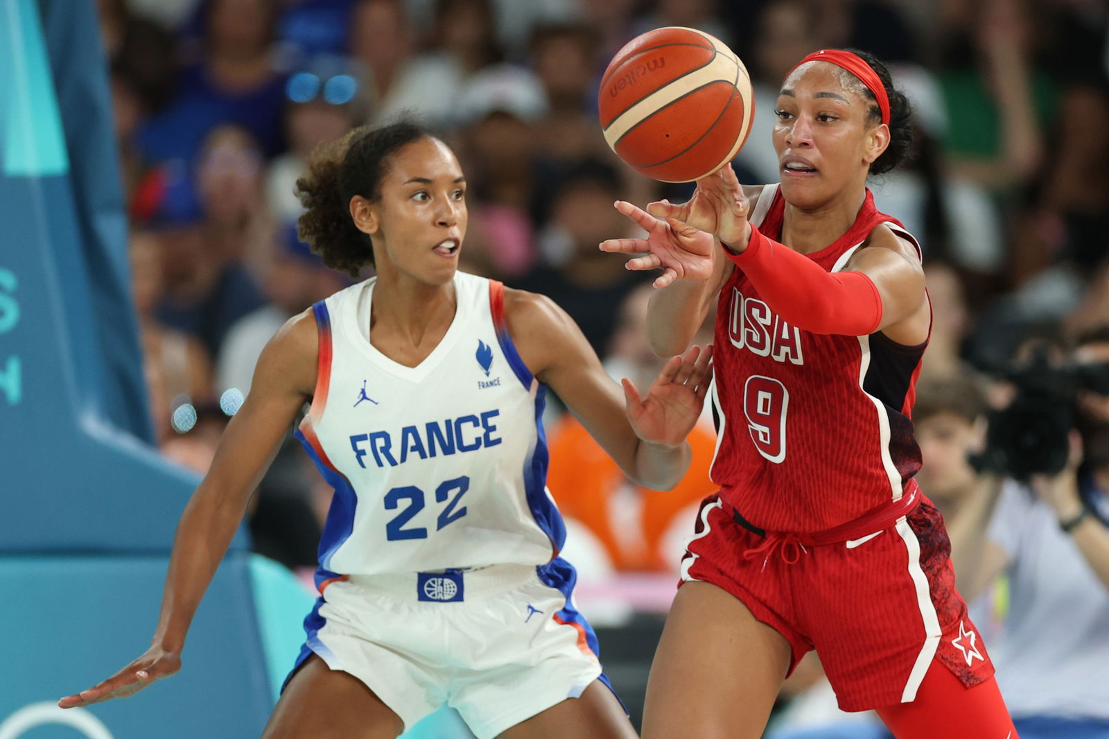  A'Ja Wilson #9 of Team United States passes the ball while defended by Marieme Badiane #22 of Team France during the Women's Gold Medal game