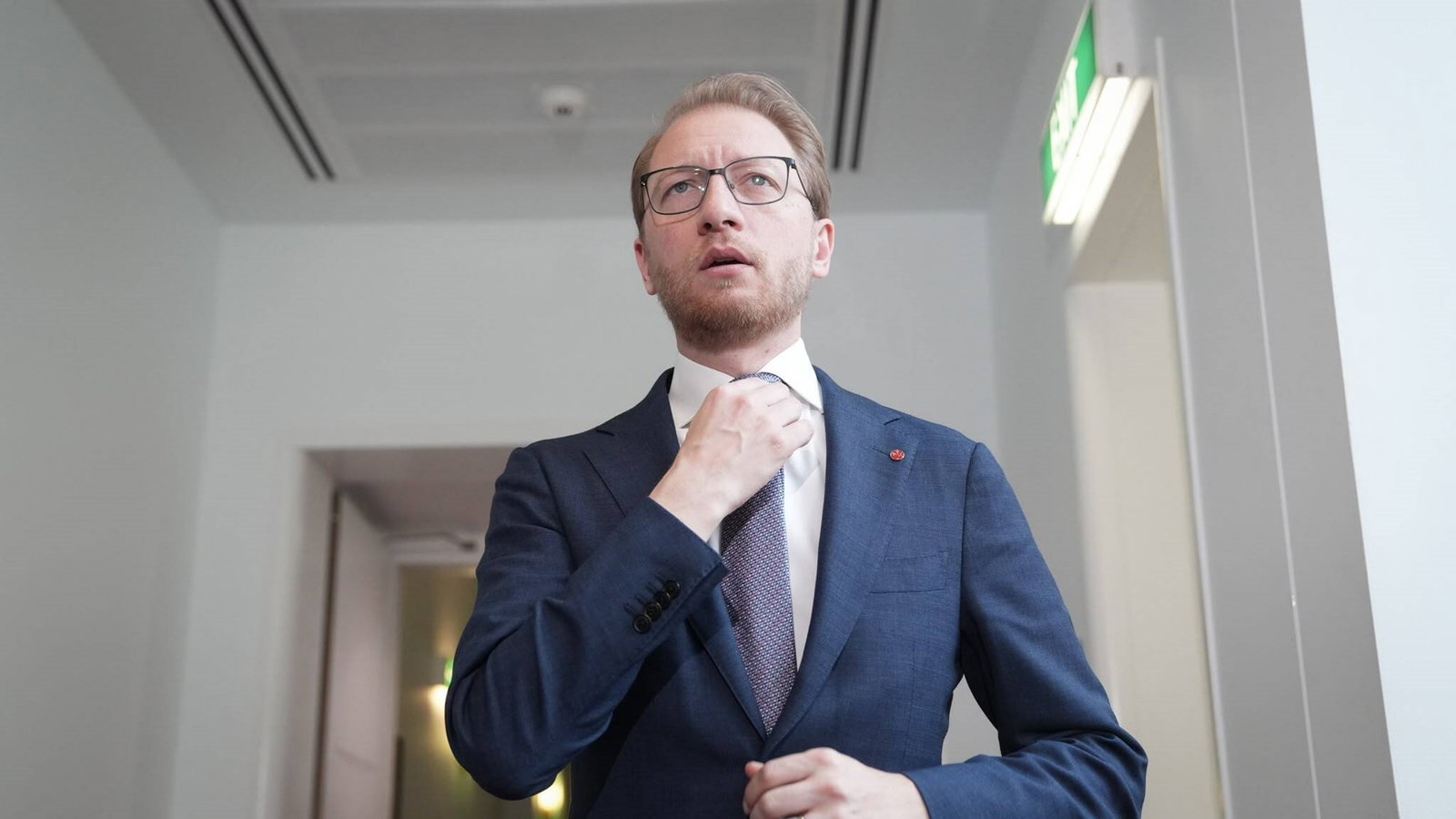 James Paterson adjusts his tie.