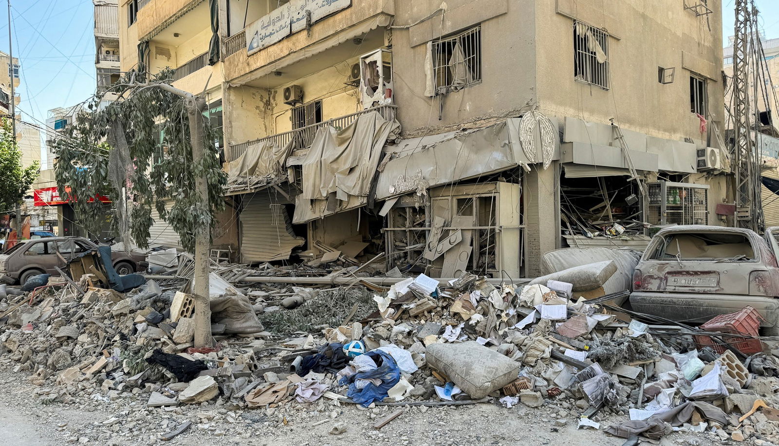 A pile of debris outside a building, covered in dust