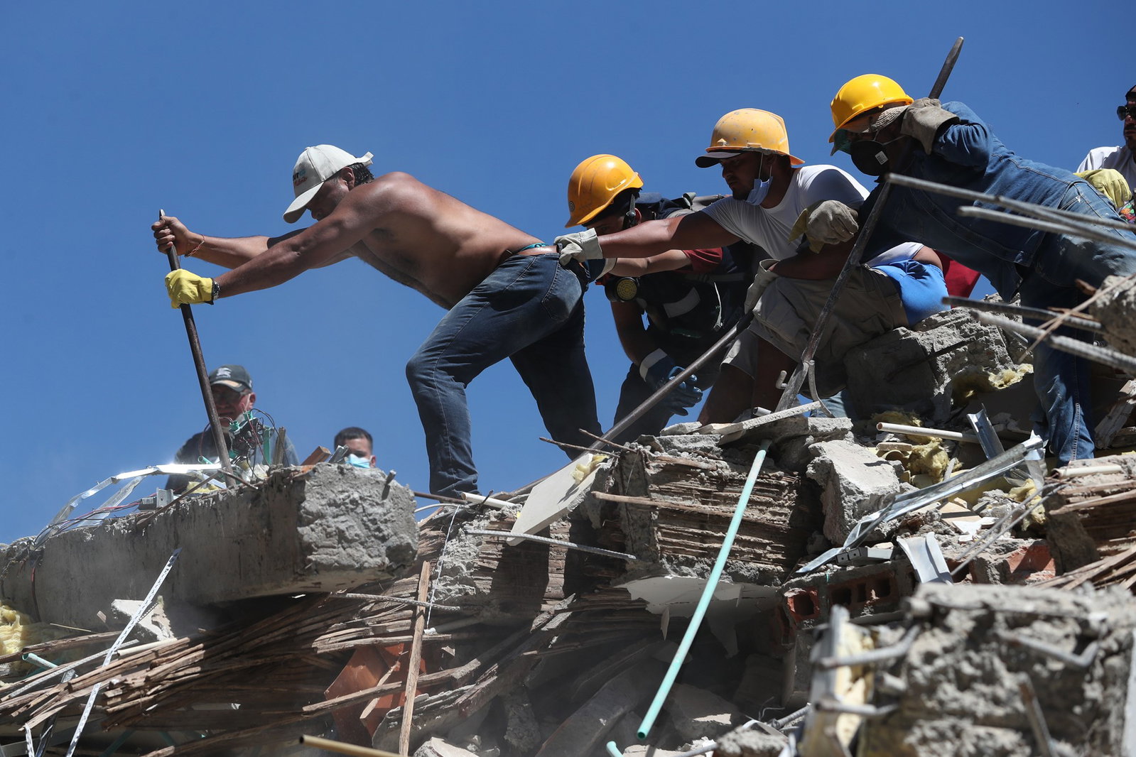 Four men trying to lift concrete up