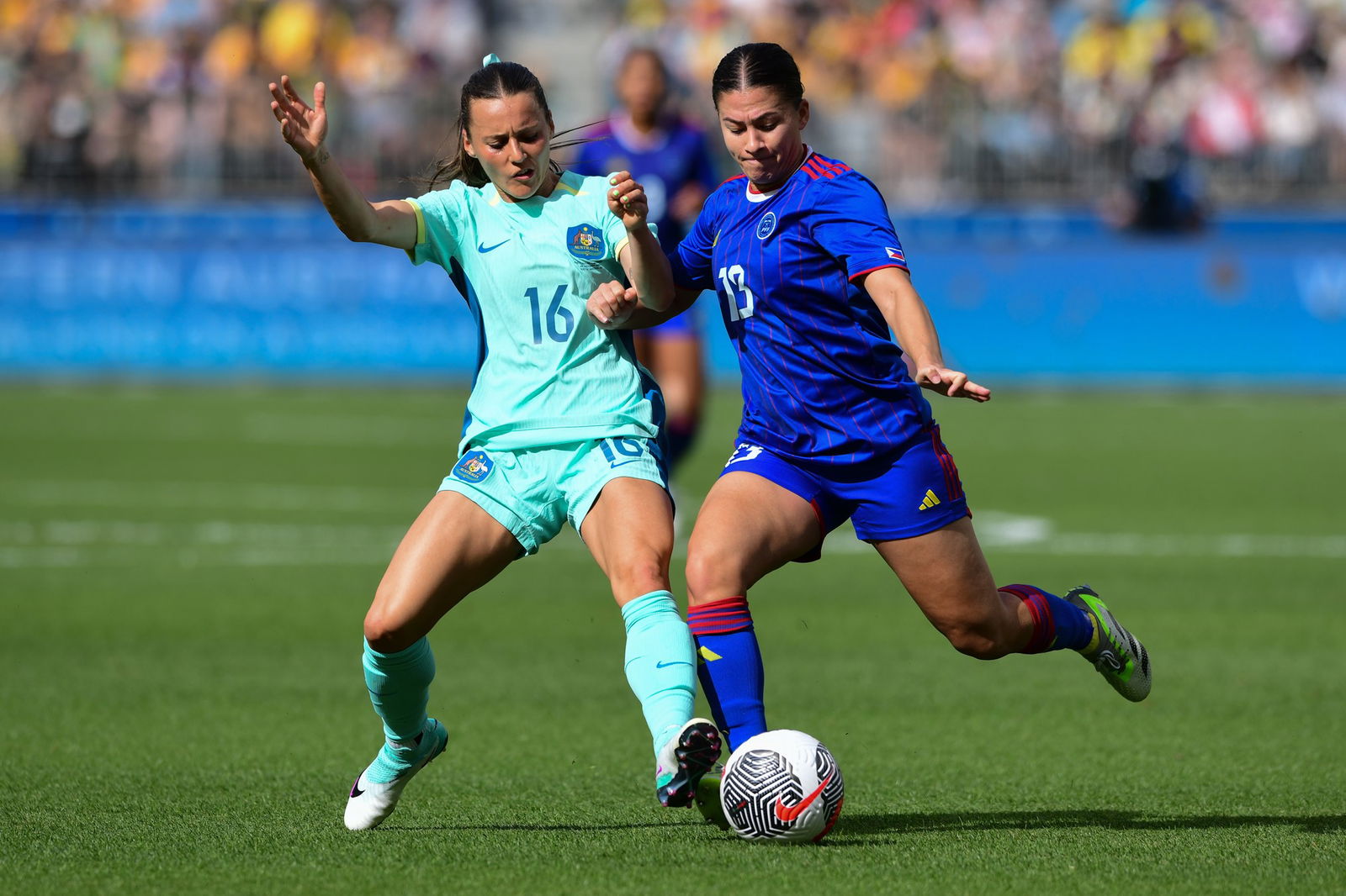 Hayley Emma Raso (l) del equipo de fútbol femenino australiano y Angela Rachael Beard (r) del equipo de fútbol femenino de Filipinas se ven en acción durante el partido del Grupo A de la Ronda 2 de Clasificación Olímpica de Fútbol Femenino de la AFC 2024 entre Filipinas y Australia en Perth.