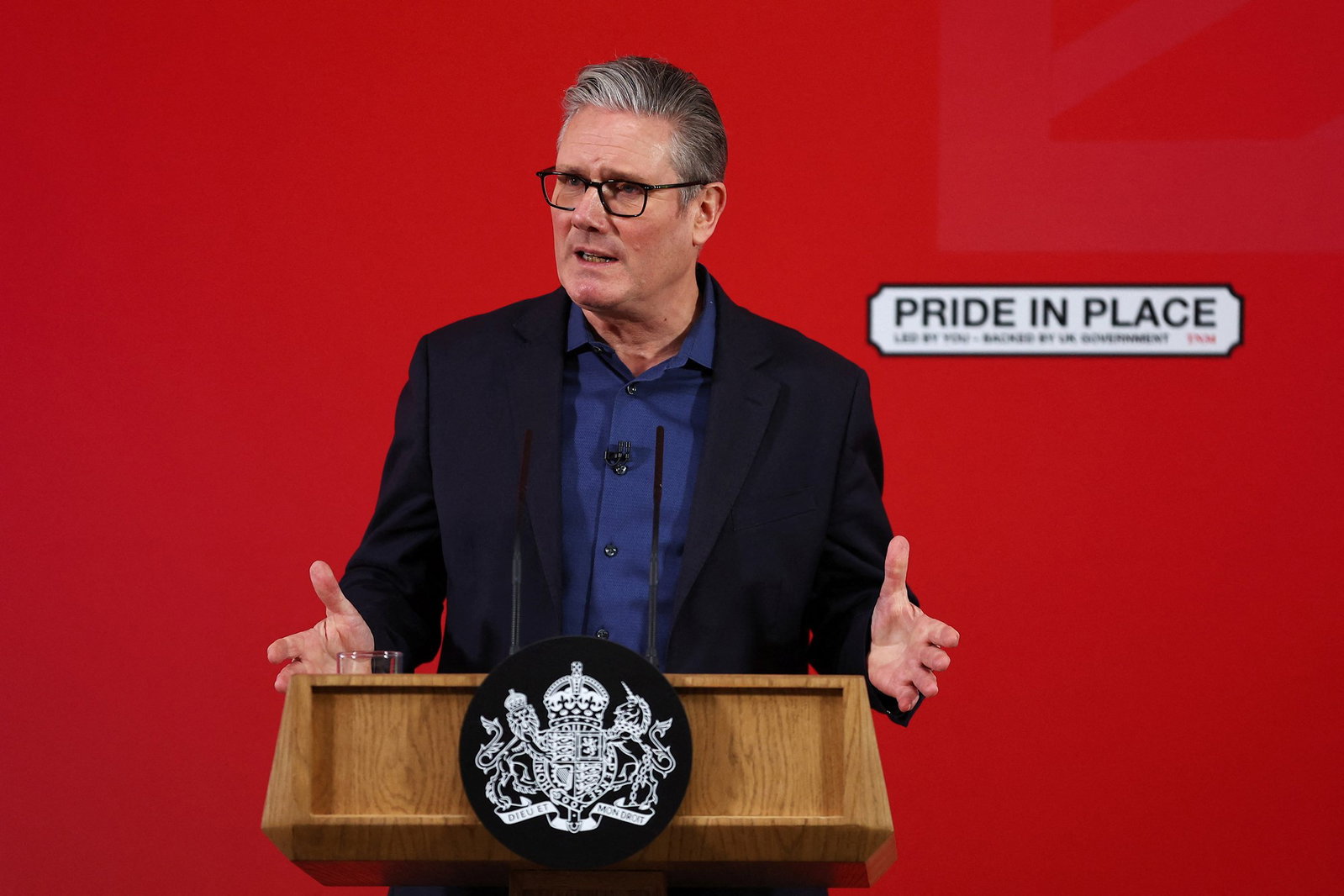 Keir Starmer talks behind an official lectern.
