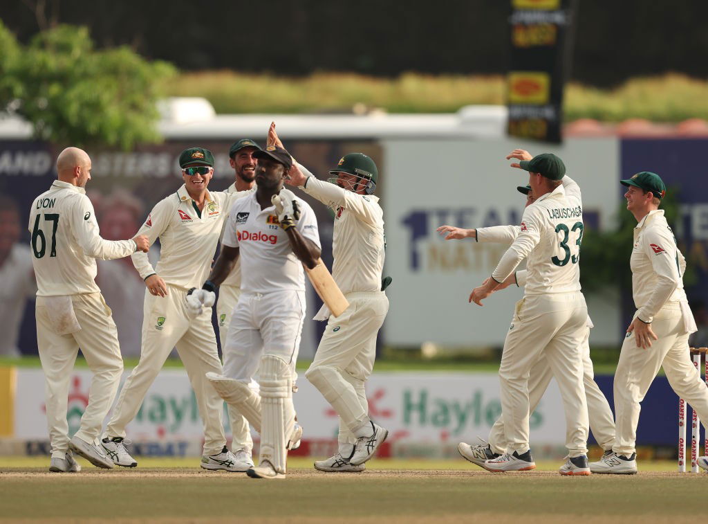  Angel Mathews walks off after being dismissed while Australia celebrates.