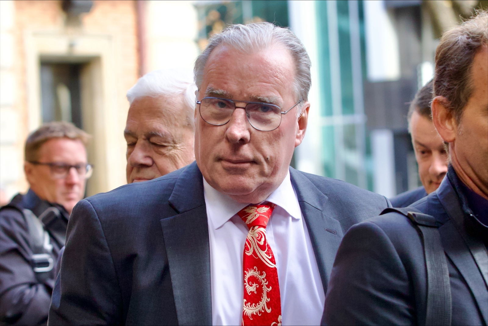 Martin Bennett in a suit jacket and red tie.