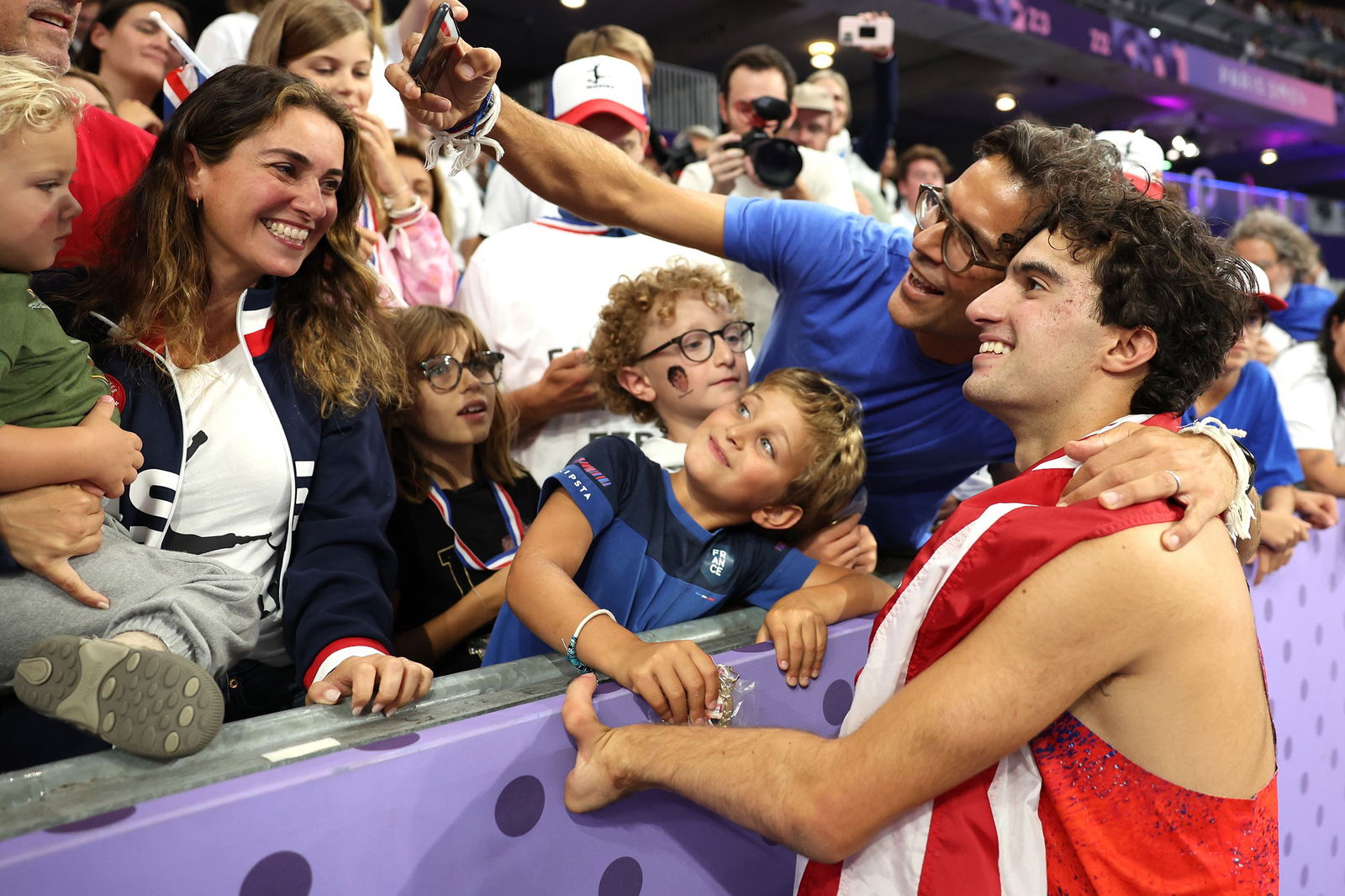 American Ezra Frech poses for a selfie with fans after the men's high jump T63 final in Paris. 