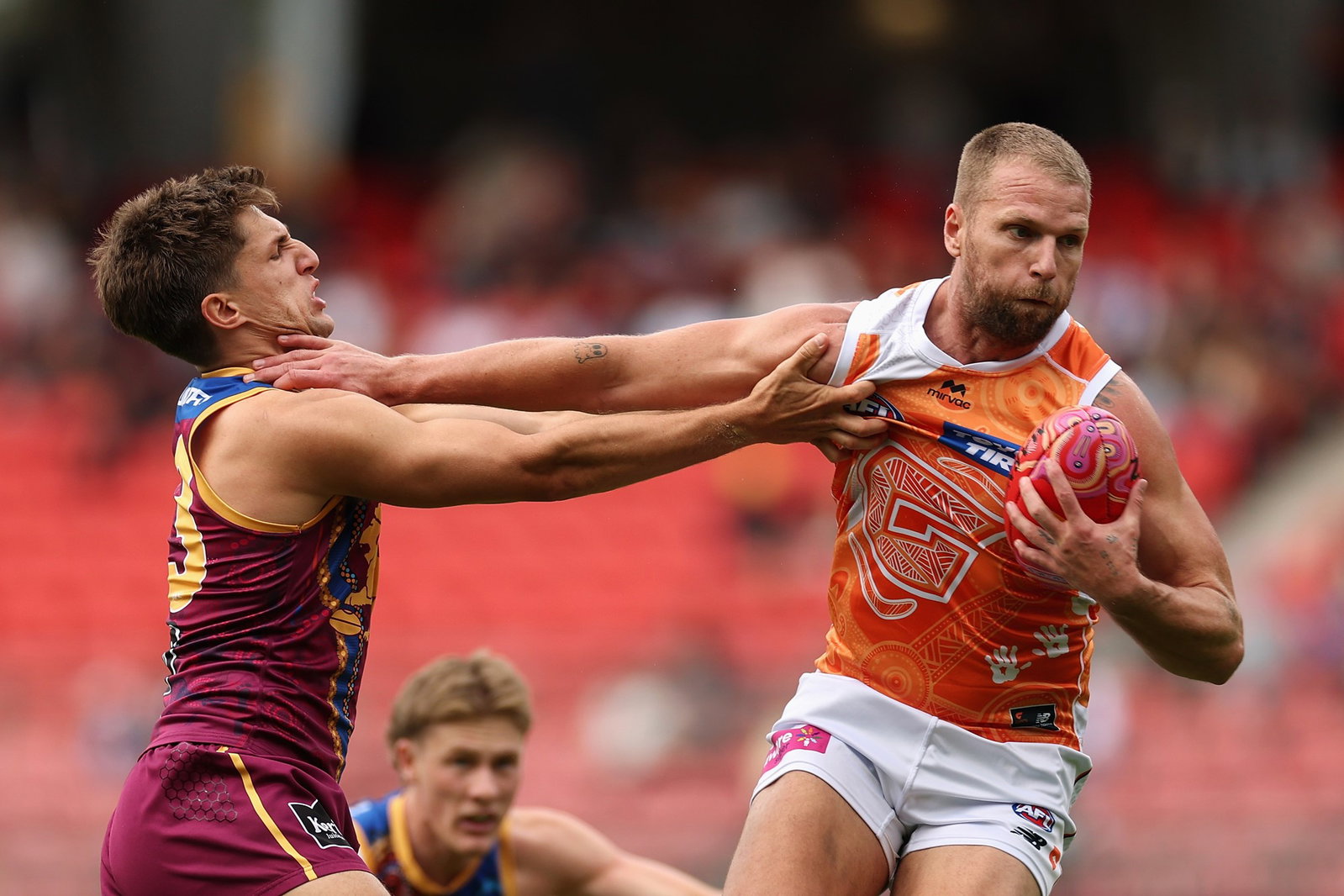 Jake Stringer of the Giants fends off Zac Bailey of the Lions during the round 11 AFL match between Greater Western Sydney Giants and Brisbane Lions on May 24, 2026, in Sydney, Australia.