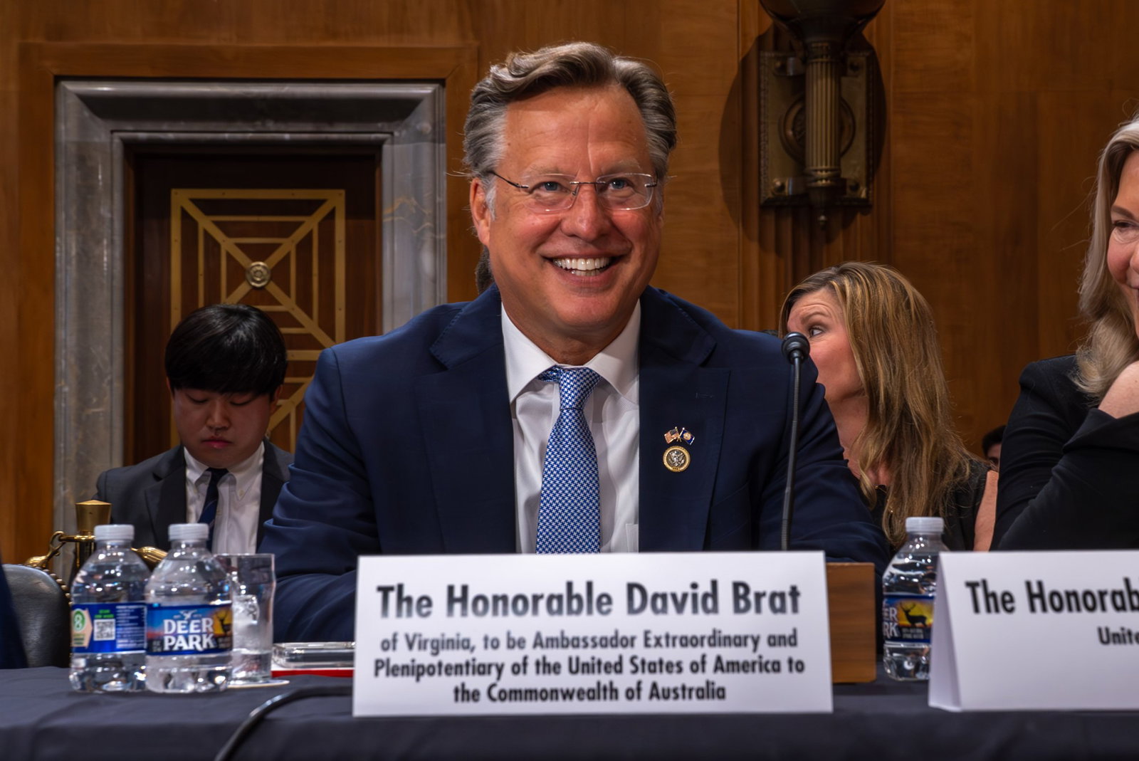 David Brat sits at a desk and smiles.