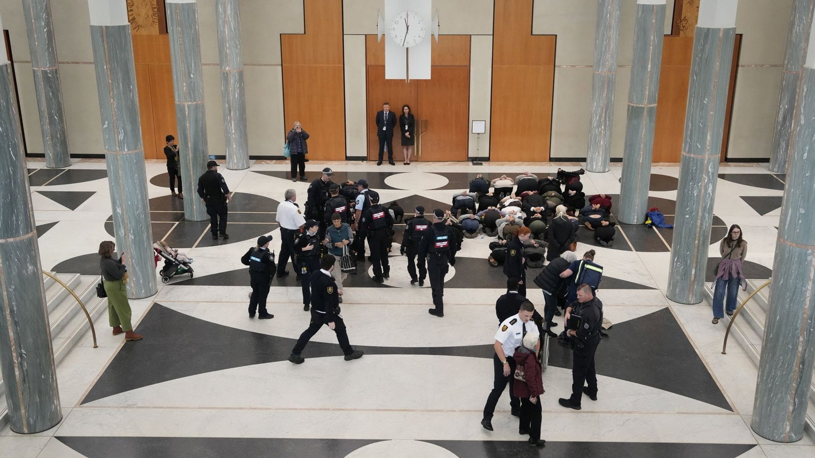 Police usher away protesters in Marble Foyer.