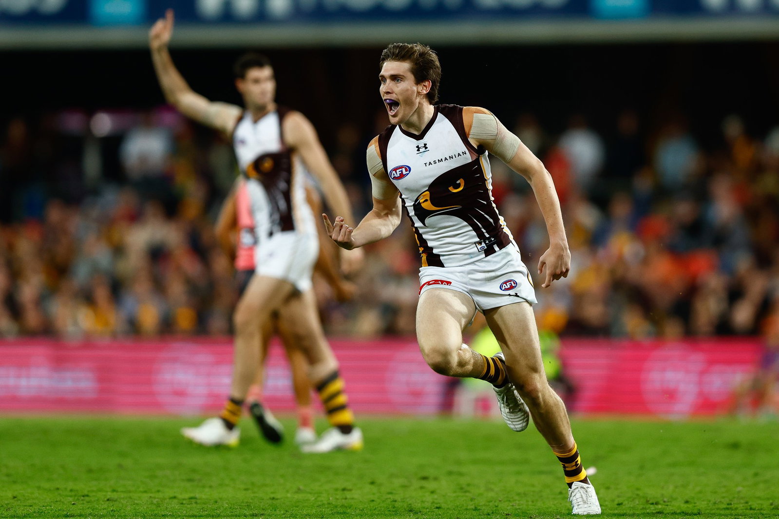 Connor Macdonald of the Hawks celebrates a goal during the round 15 AFL match between Gold Coast Suns and Hawthorn Hawks on June 19, 2026, in Gold Coast, Australia.