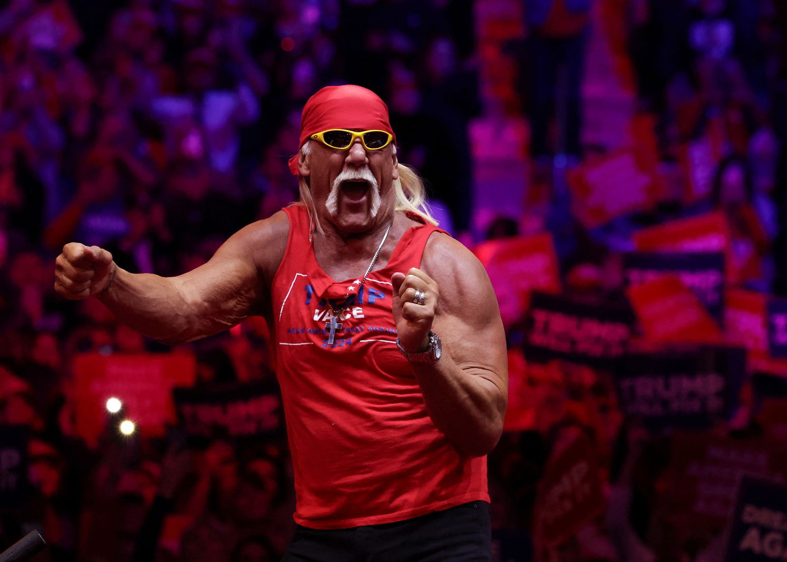 Hulk Hogan extends his arms on stage