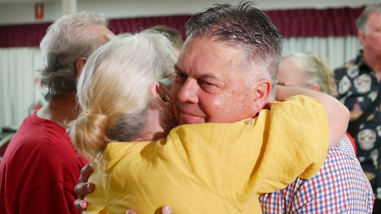 Aaron Harper hugs a supporter.