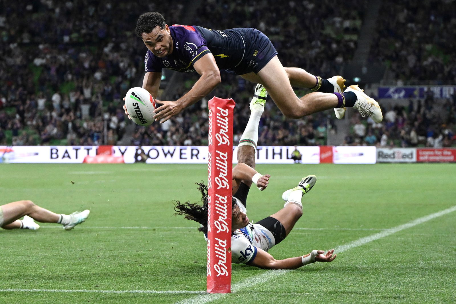 Xavier Coates dives in for a try during a Melbourne Storm NRL game.