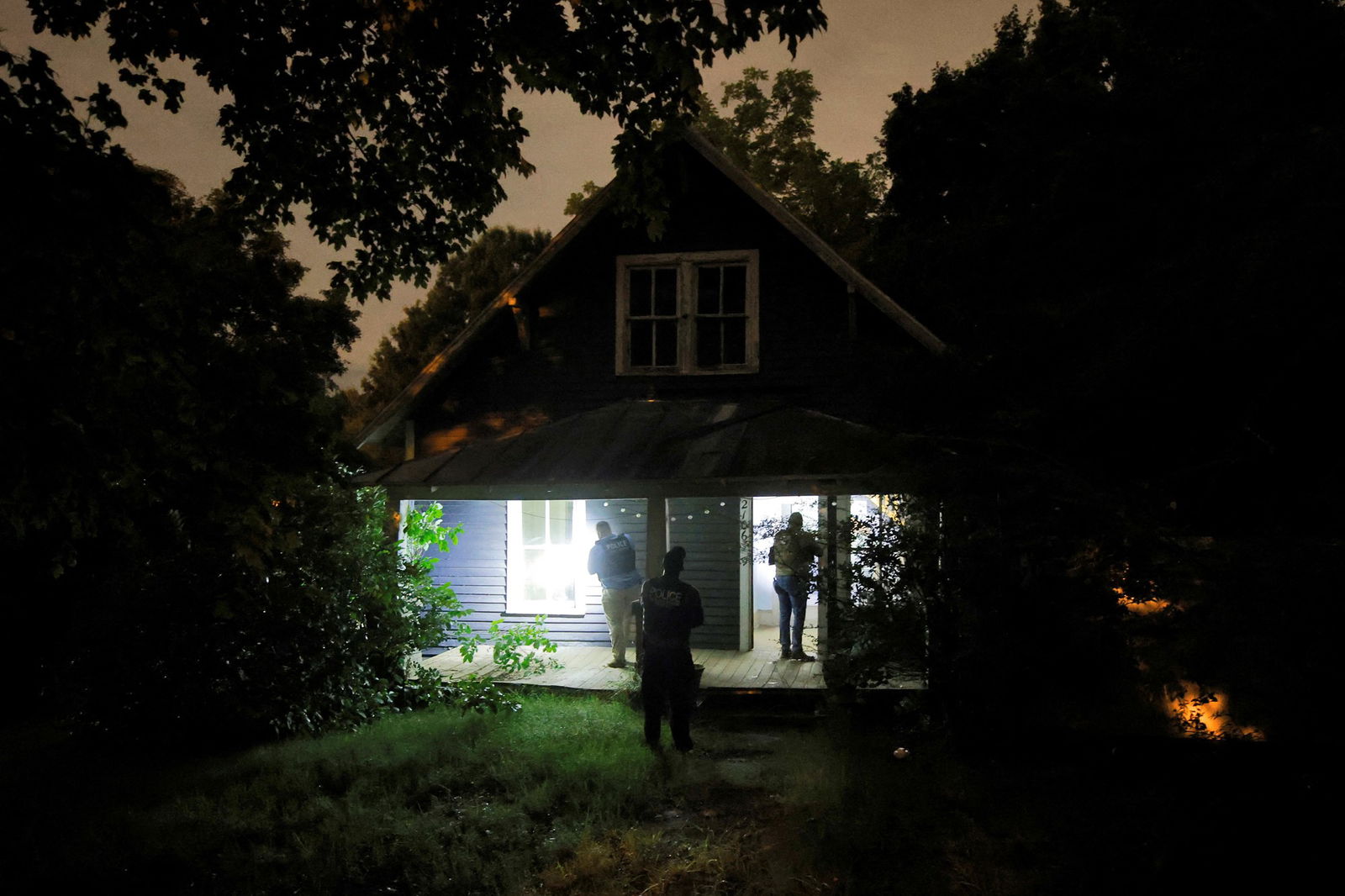 Police in the dark check a home