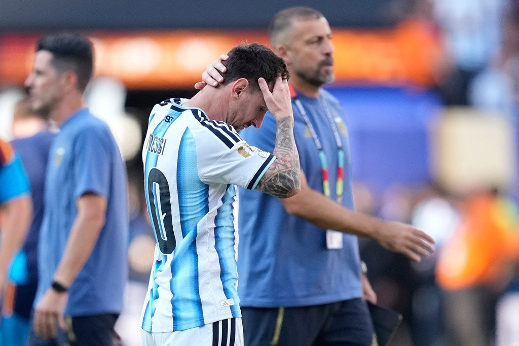 Messi holds his head after the final whstle.