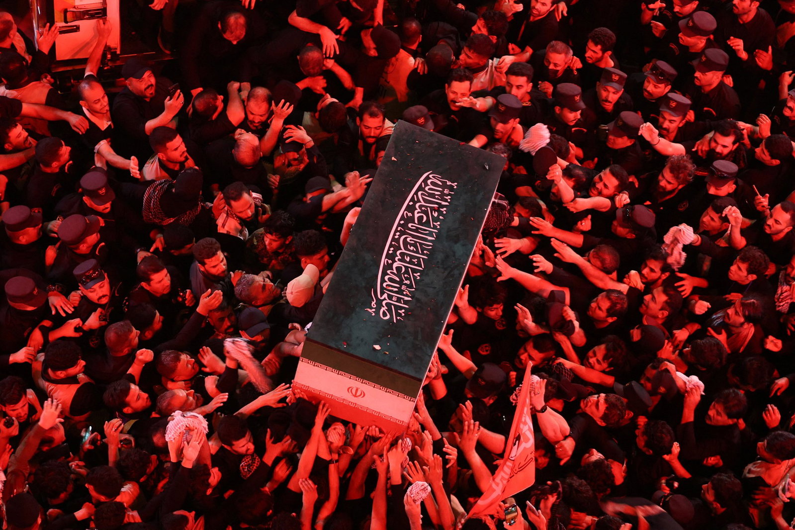 Ali Khamenei's coffin being carried by a large crowd