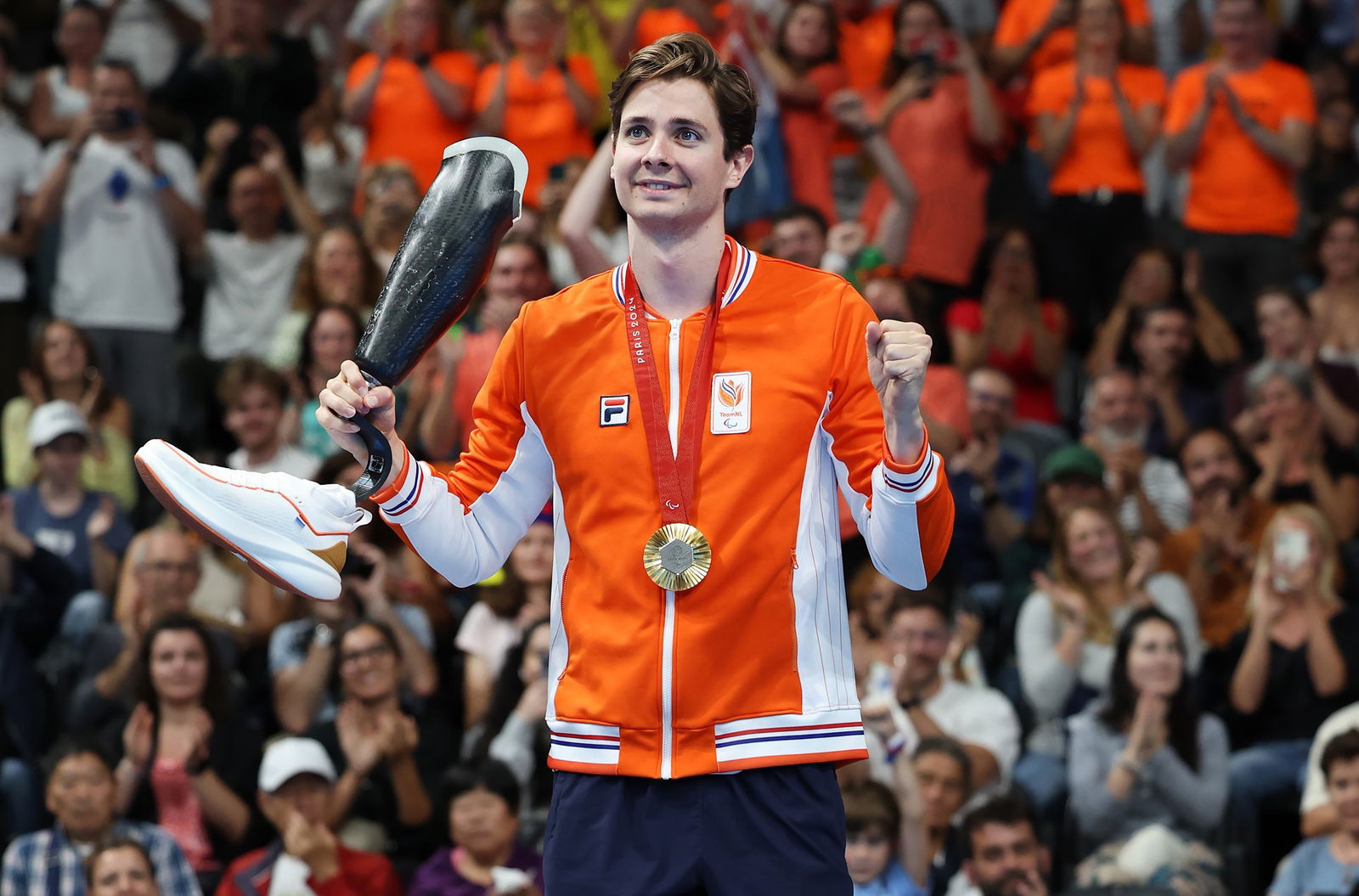 Olivier van de Voort of Team Netherlands celebrates on the podium after taking Gold in the Men's 100m Backstroke S10 final.