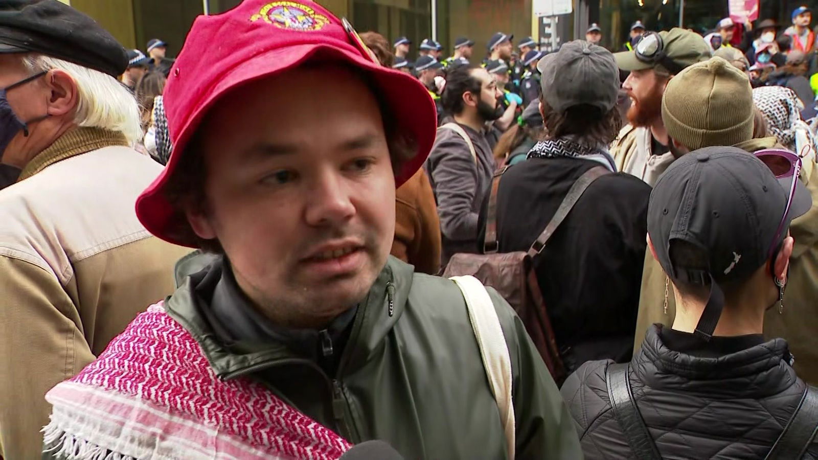 A man in a bucket hat at a protest