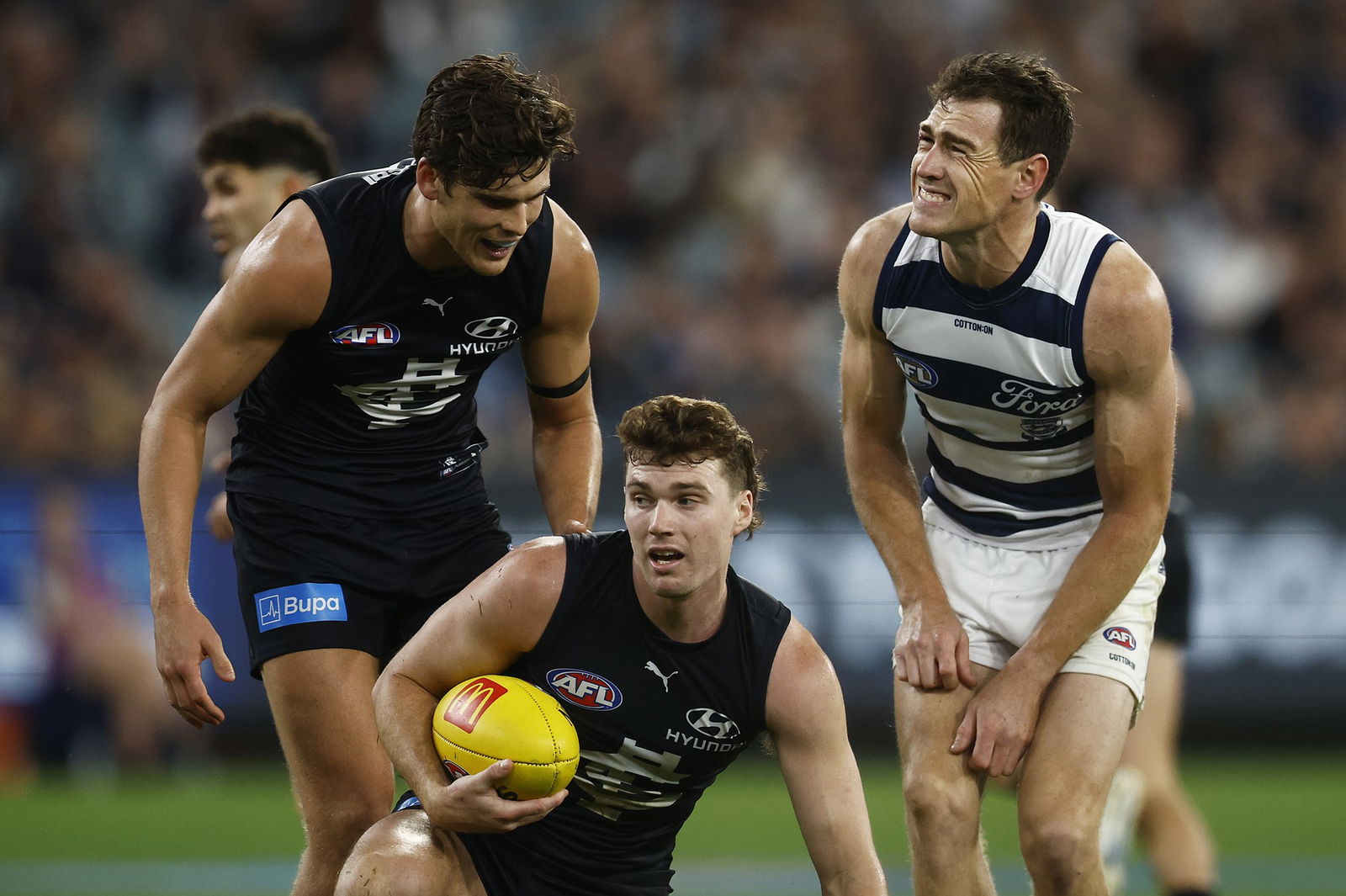 Geelong's Jeremy Cameron reacts after a contest with Carlton's Blake Acres.