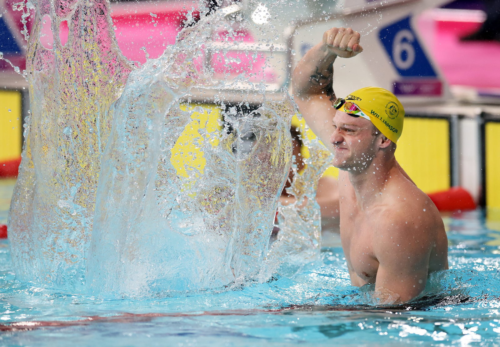 Sam Williamson splashing the water with a smile on his face