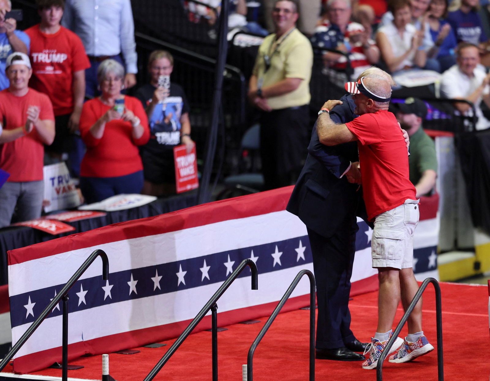 Donald Trump embraces a supporter on stage