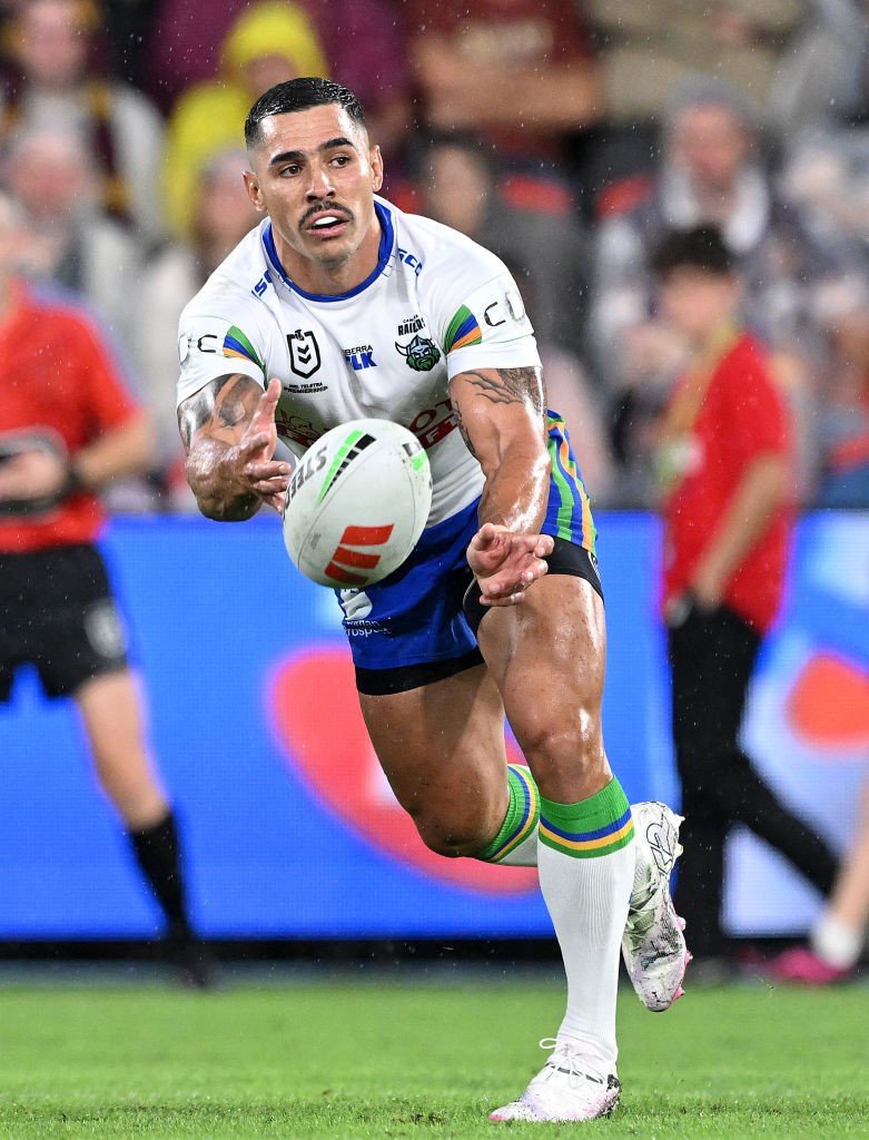 Jamal Fogarty of the Canberra Raiders throws a pass in an NRL game.