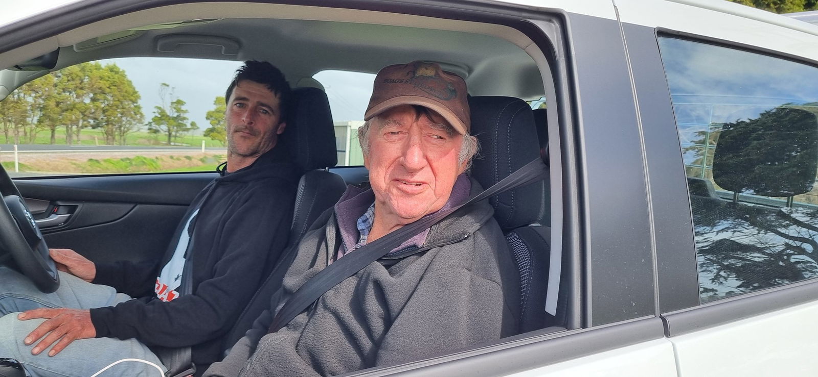 Anthony and Andrew sit in the front seats of a car