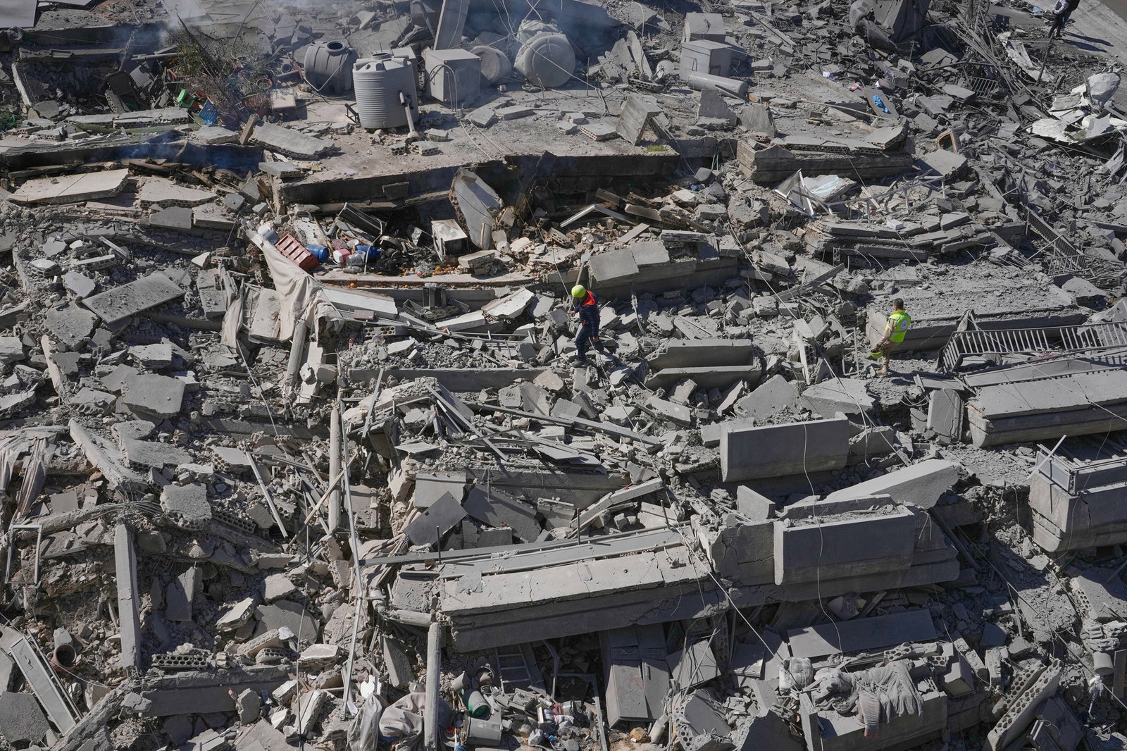 Rescue workers check a destroyed building that was hit by an Israeli airstrike in Nabatiyeh town.
