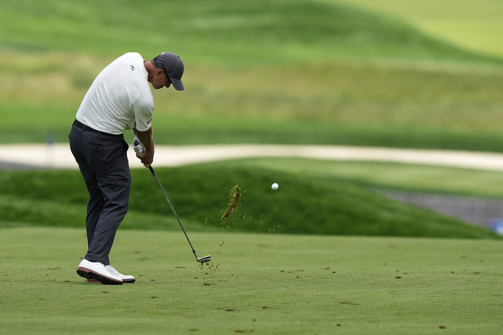 Adam Scott hits a ball in the first round at the US Open.