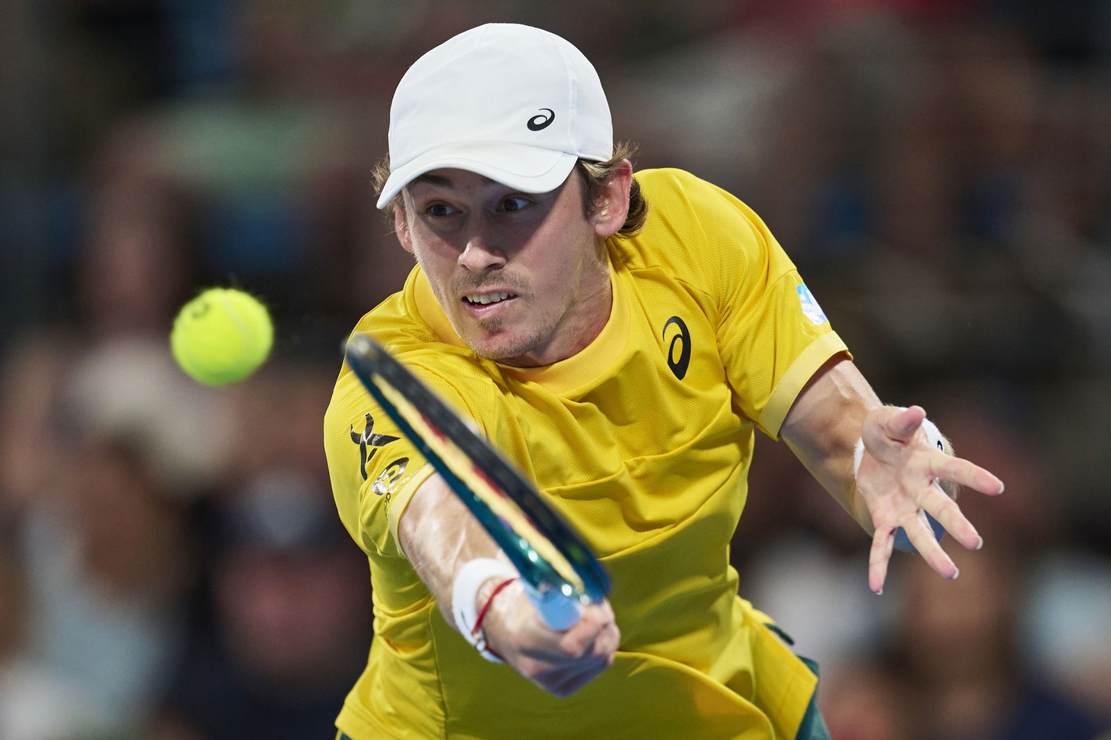 Alex de Minaur stretches for a backhand.