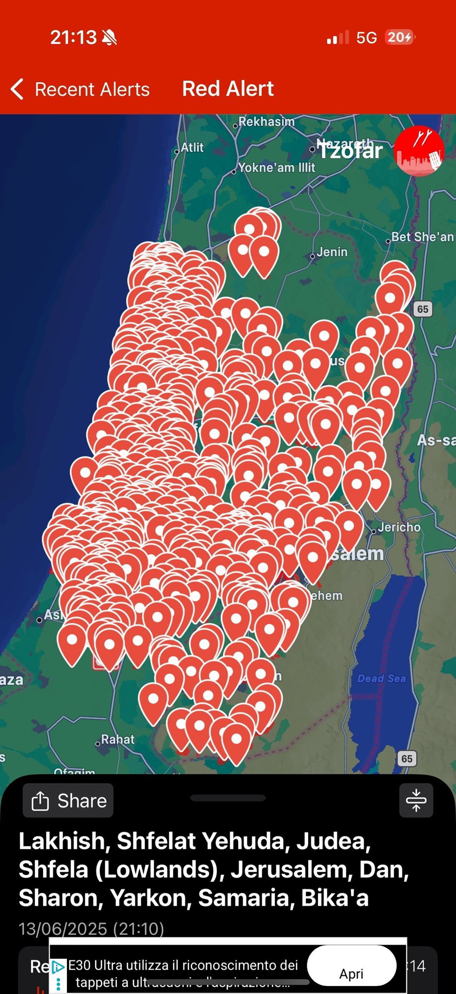 Hundreds of red pens are on a green colored map of Israel