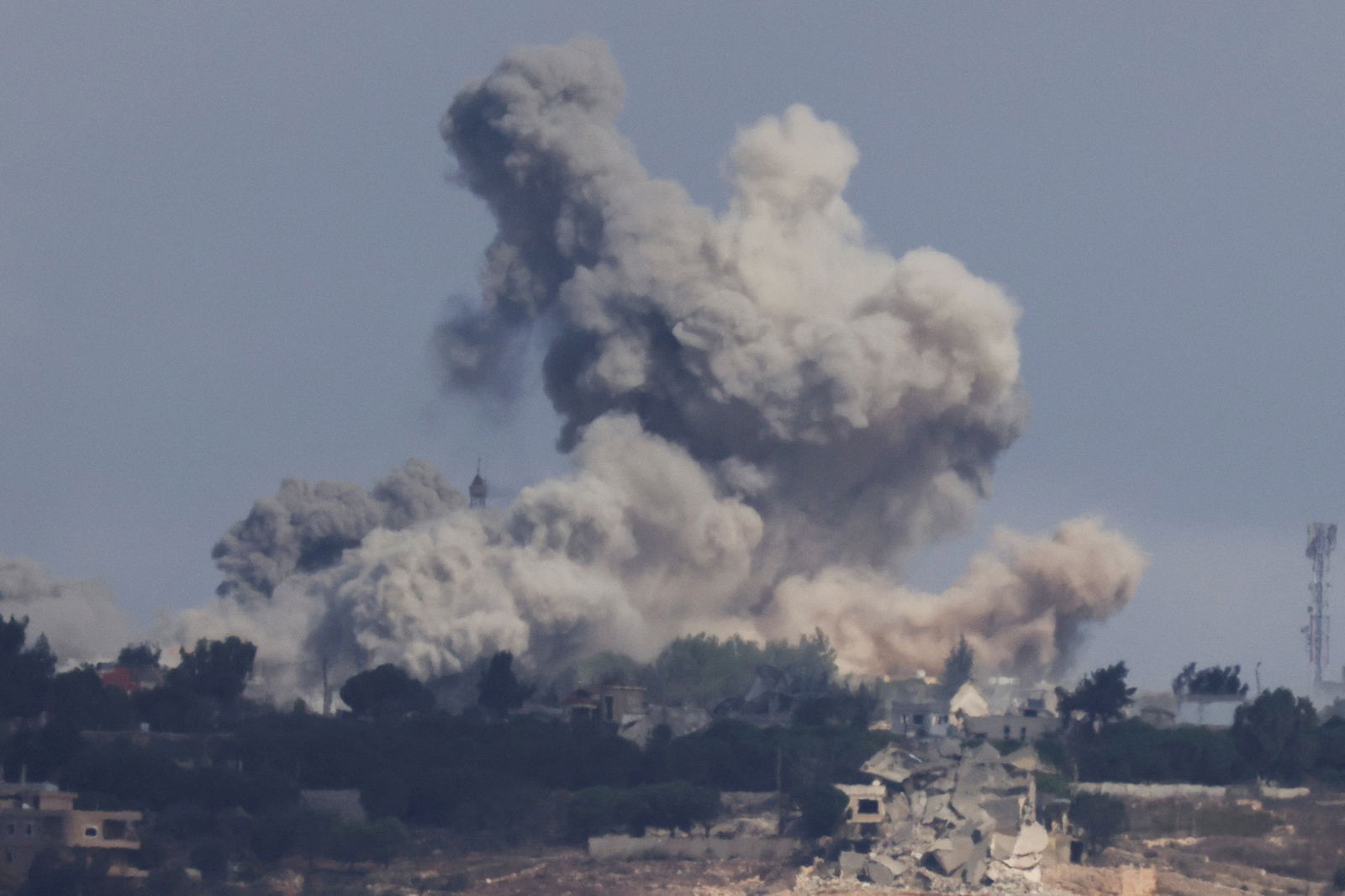 A cloud of smoke rises from a town