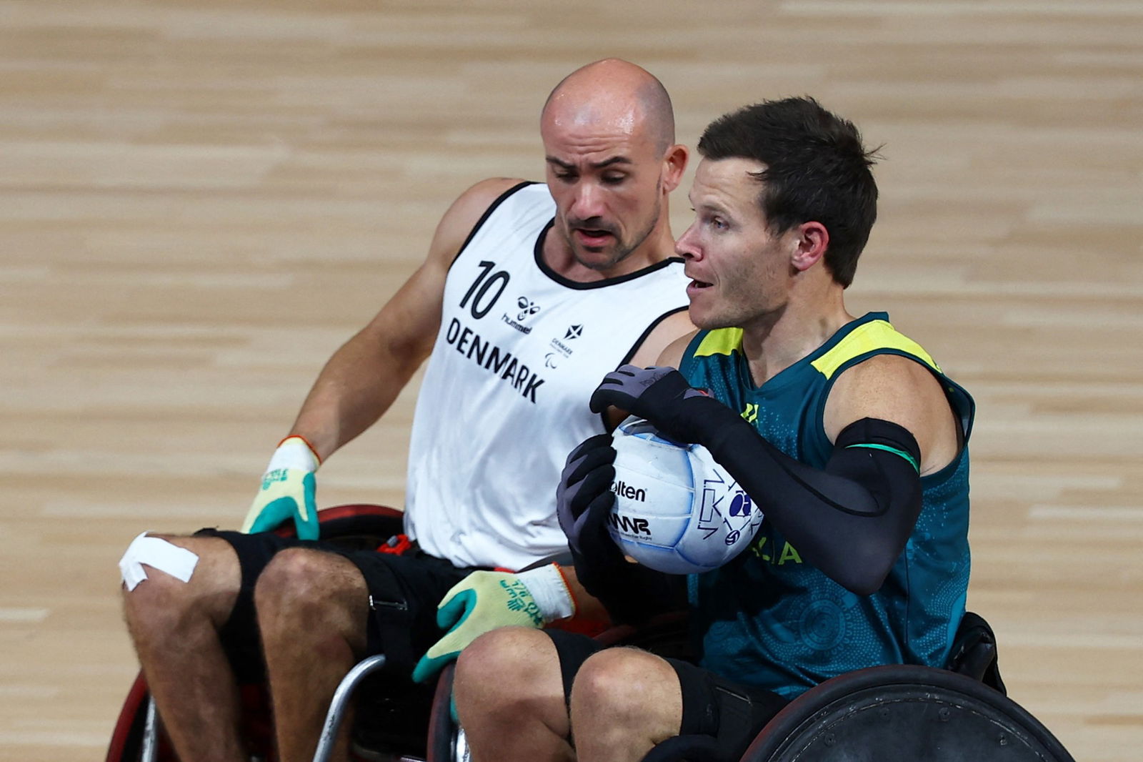 Two male wheelchair rugby players in action during a game.